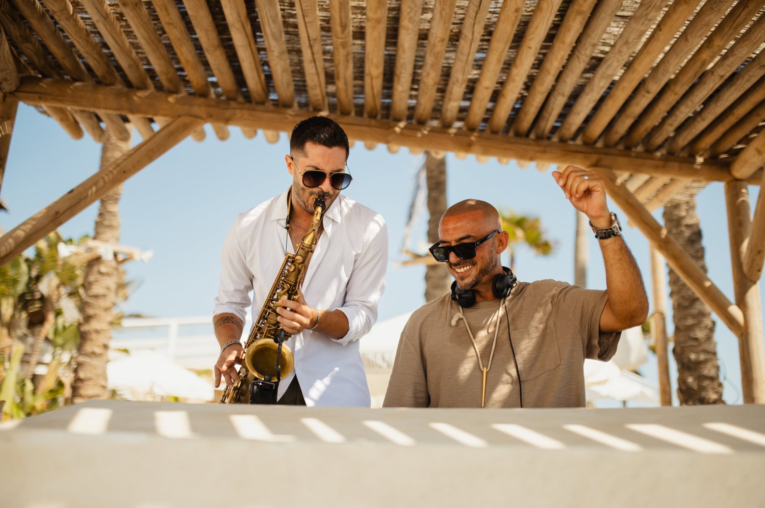 A DJ and Saxophonist playing together