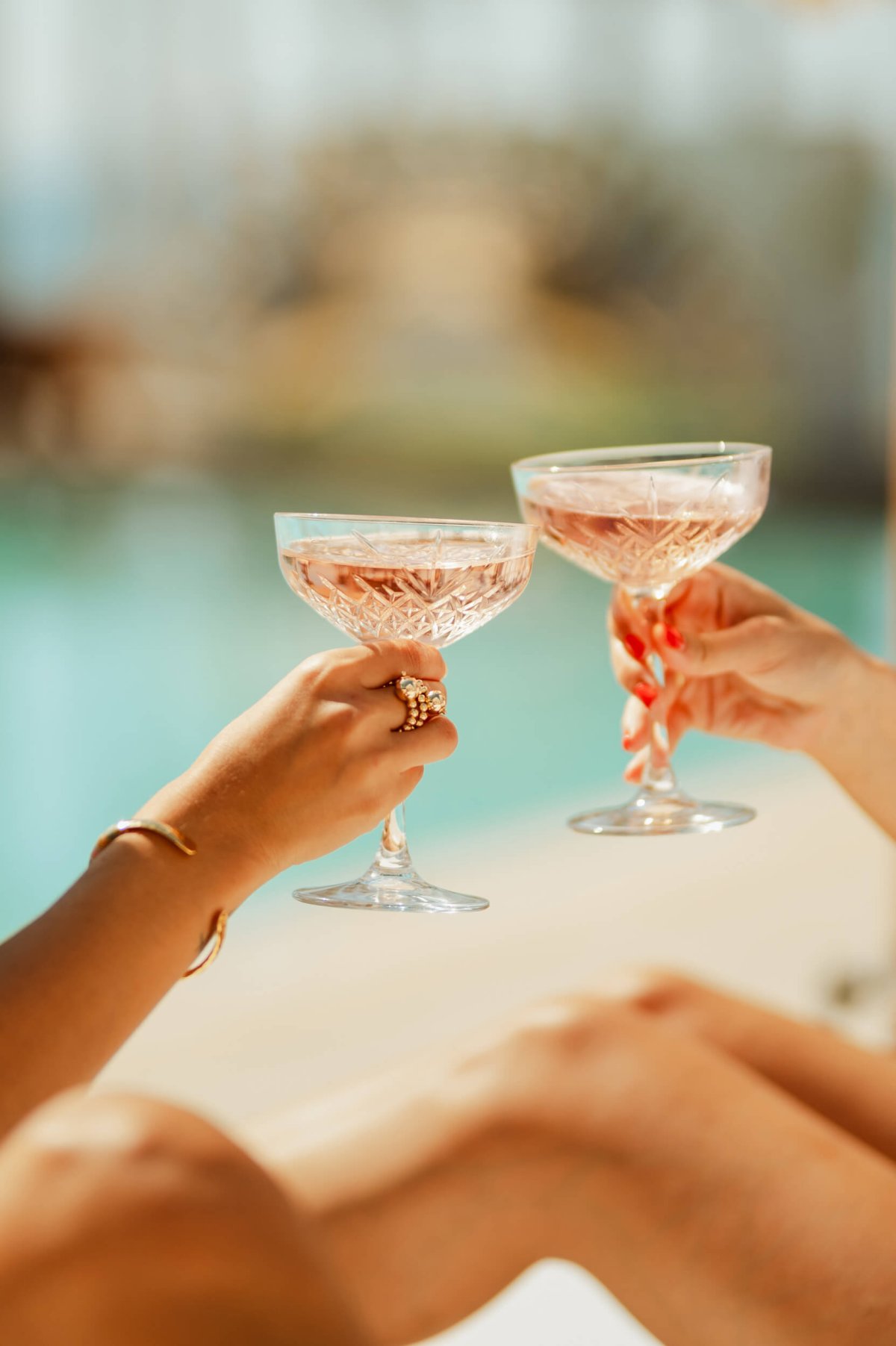 Close up of two women holding two glasses of wine