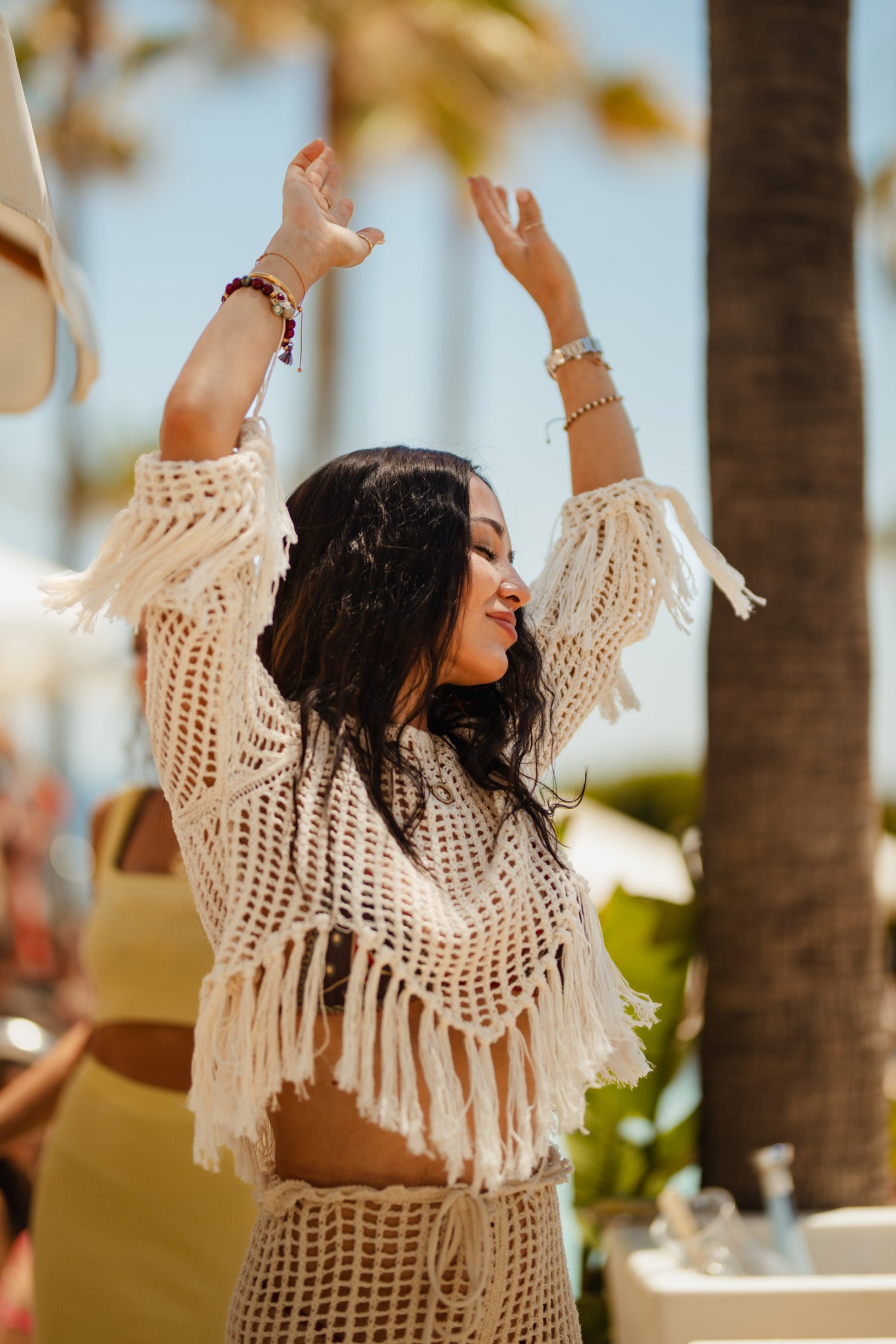 A women dancing freely, arms up in the air