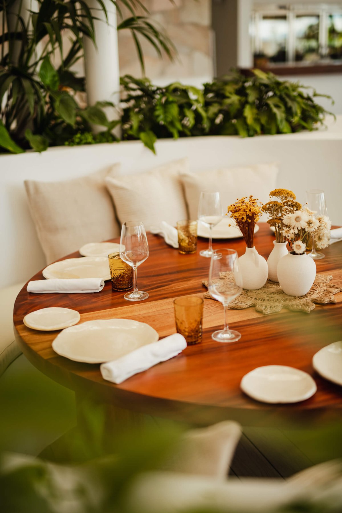 Table setting at Nikki Beach Marbella with leaves in the foreground