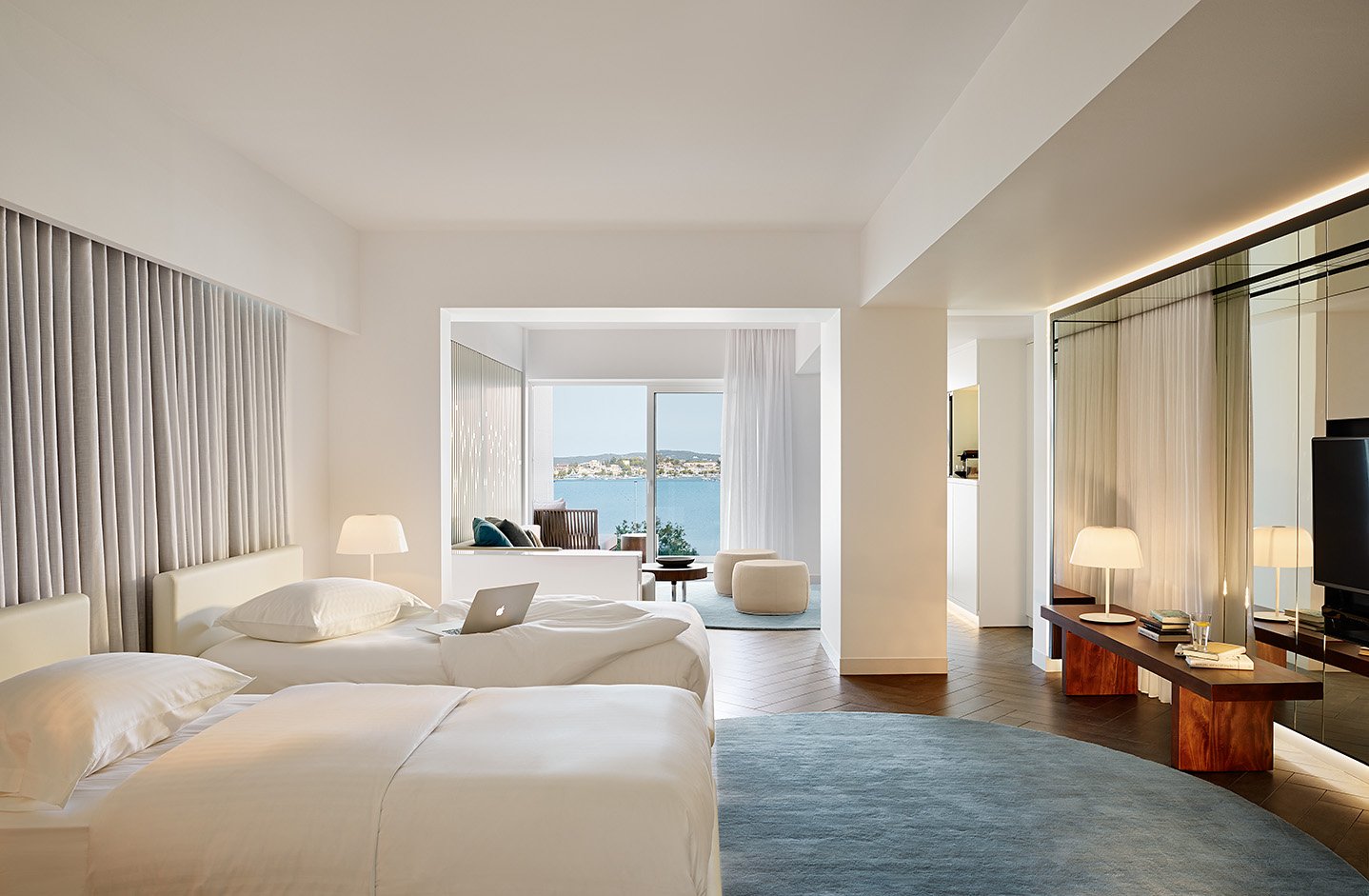 Two single beds leading through to lounge area and balcony
