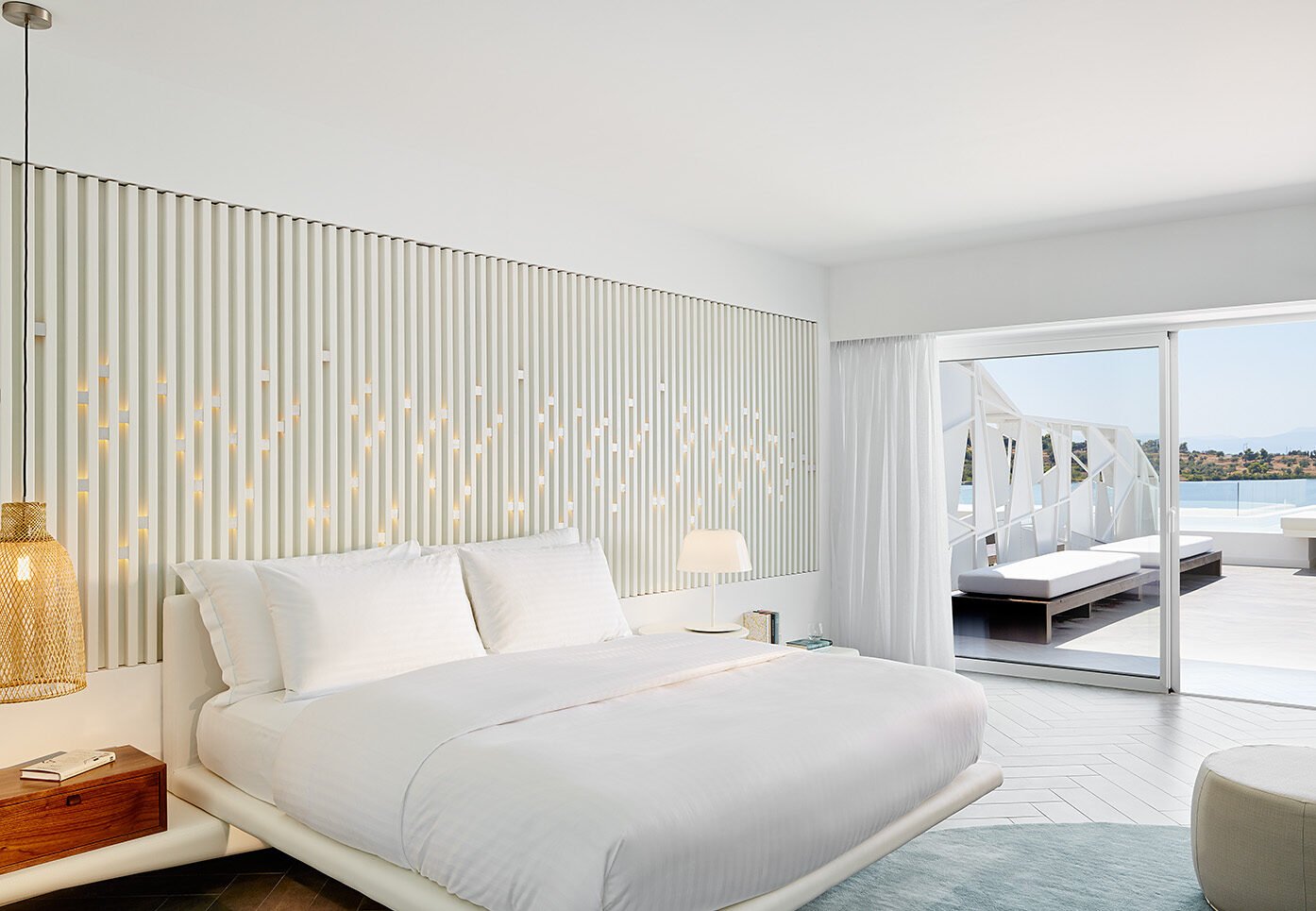 king bed with sliding doors leading out to sea view balcony