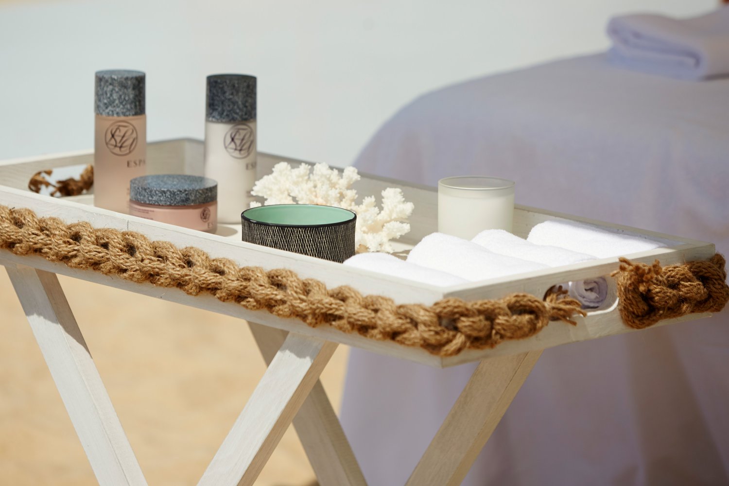 A small table of spa products and towels