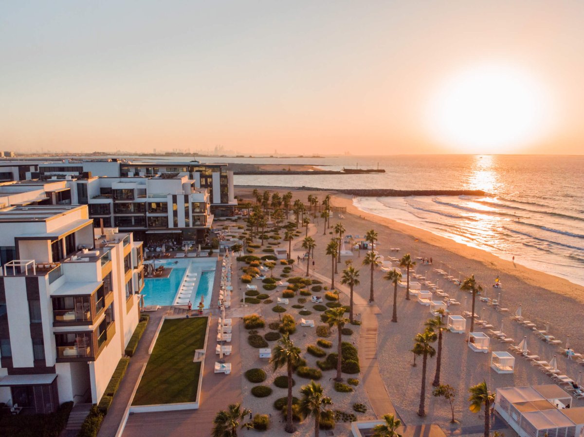 A sunset over the Nikki Beach Resort and pool