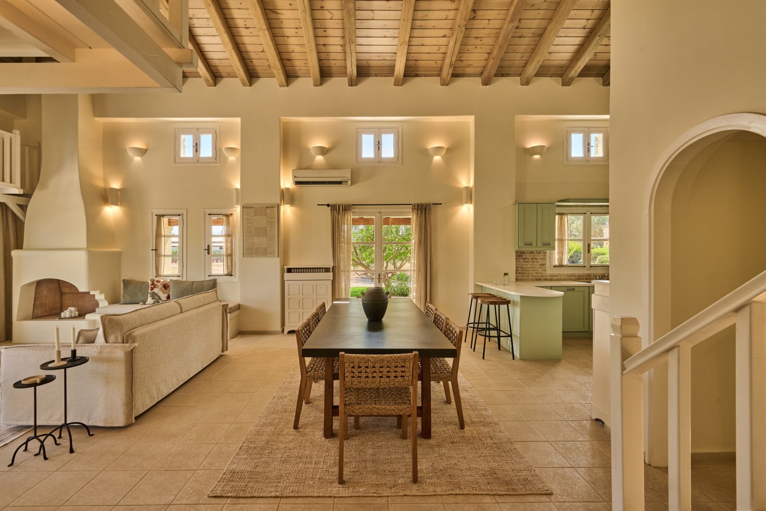 Spacious living room with a stylish dining table and chairs, perfect for gatherings in a luxurious seaside villa