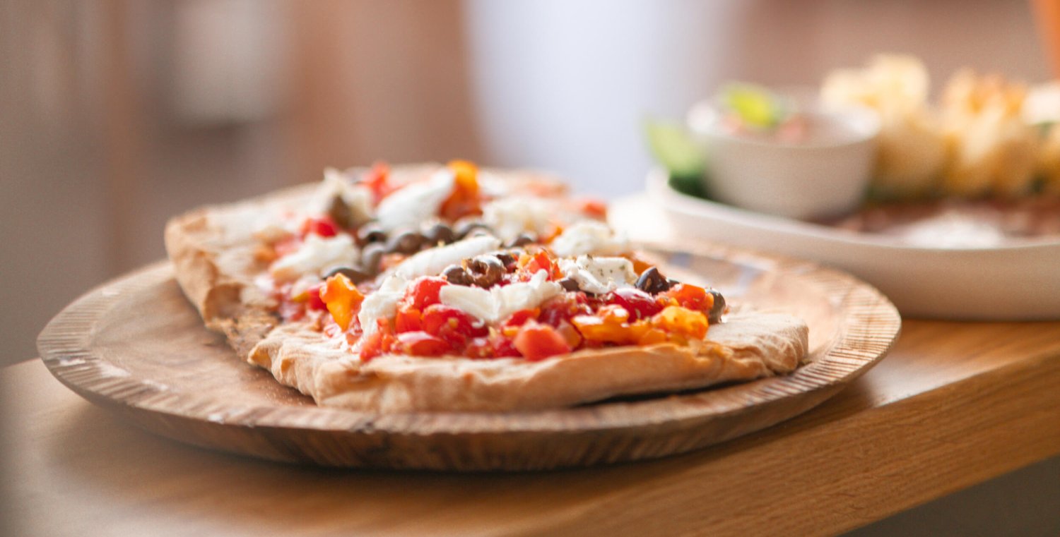 Close up of a pizza on a wooden board