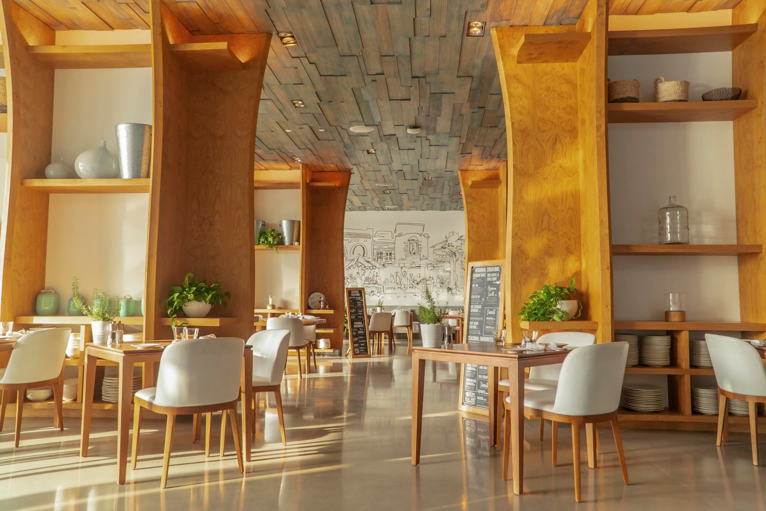 Cafe Nikki interior with dining tables, chairs and tall ceilings