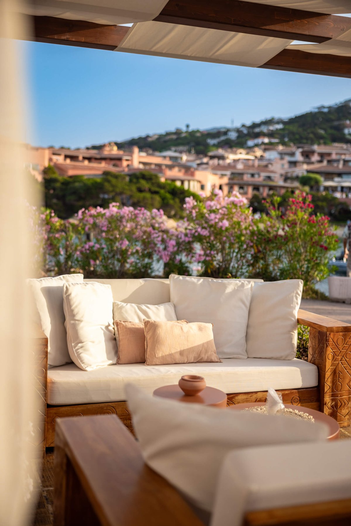 Cushioned seating area with Porto Cervo landscape in the background