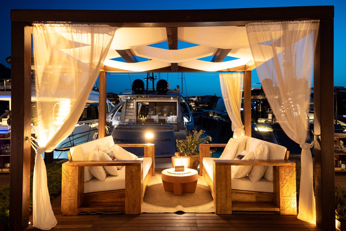 Seating area at the dock of Porto Cervo with yachts in the background