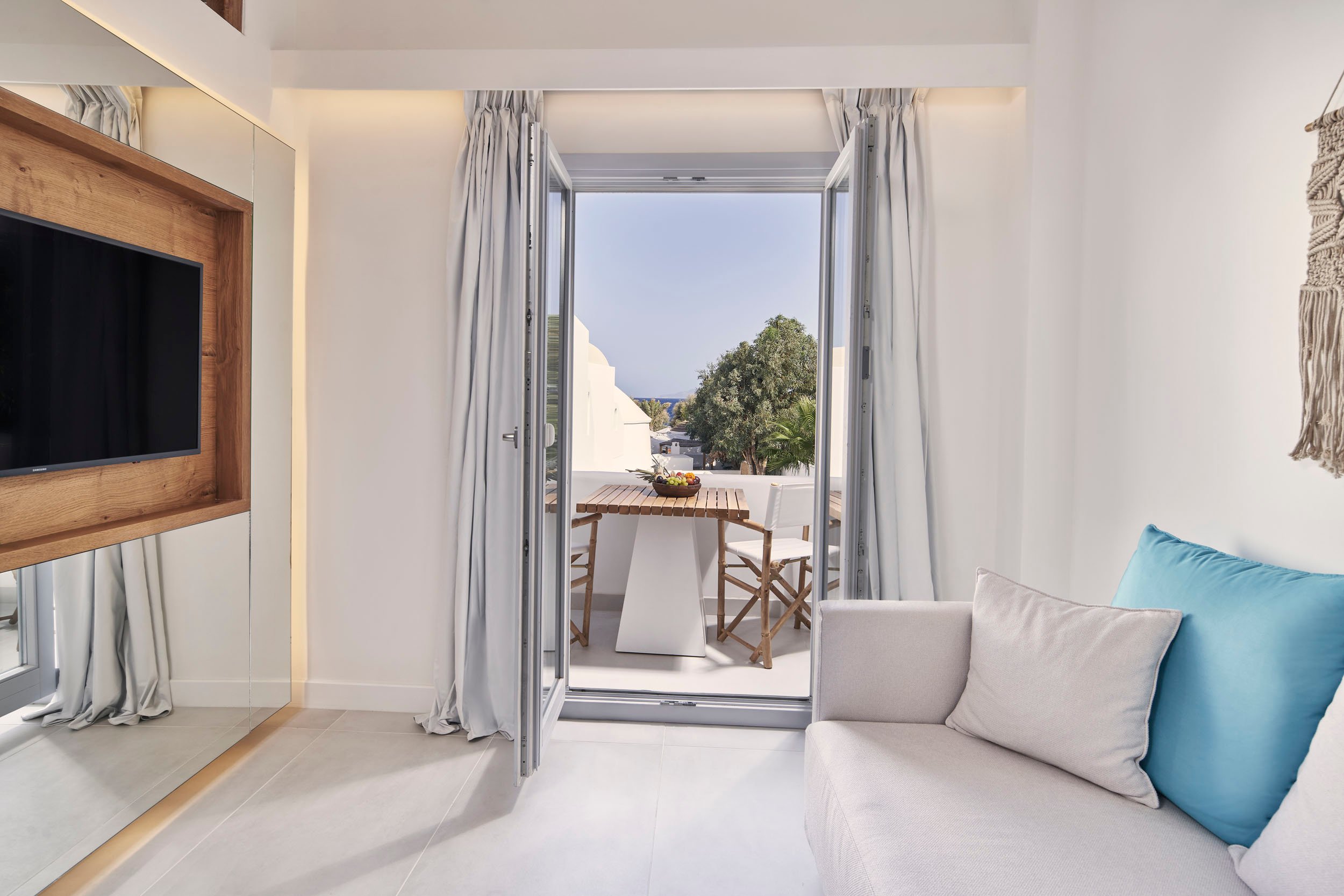 Signature Room with Jetted Tub: sofa and tv looking out to balcony area