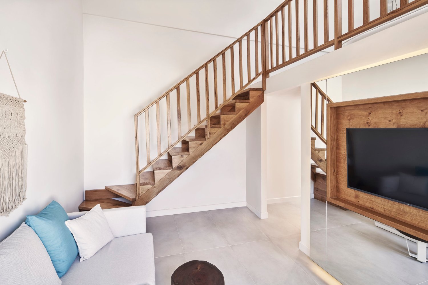 Signature Room: Tv and sofa area with stairs up to bedroom