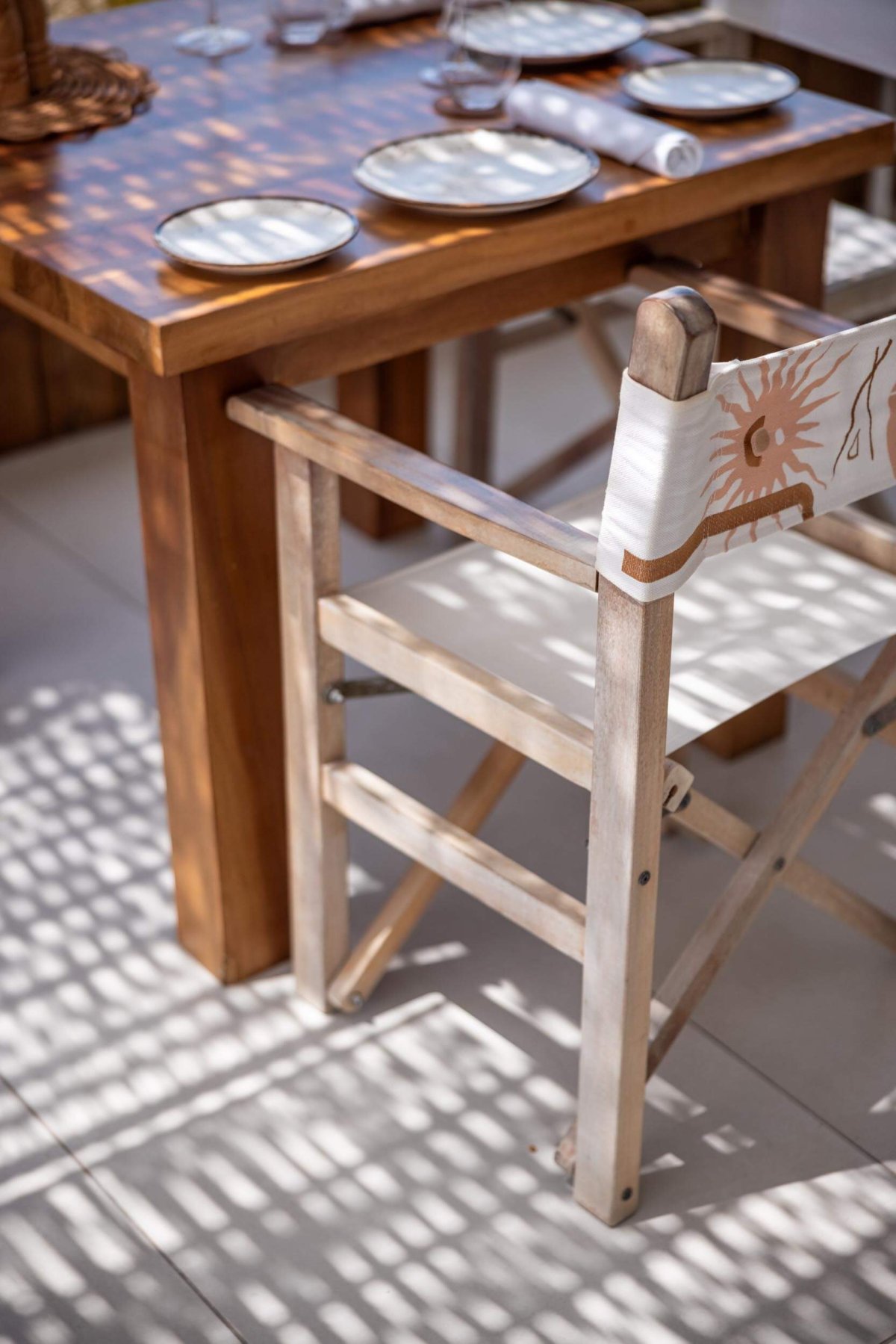 A close up shot of a Nikki beach branded dining chair tucked into a table