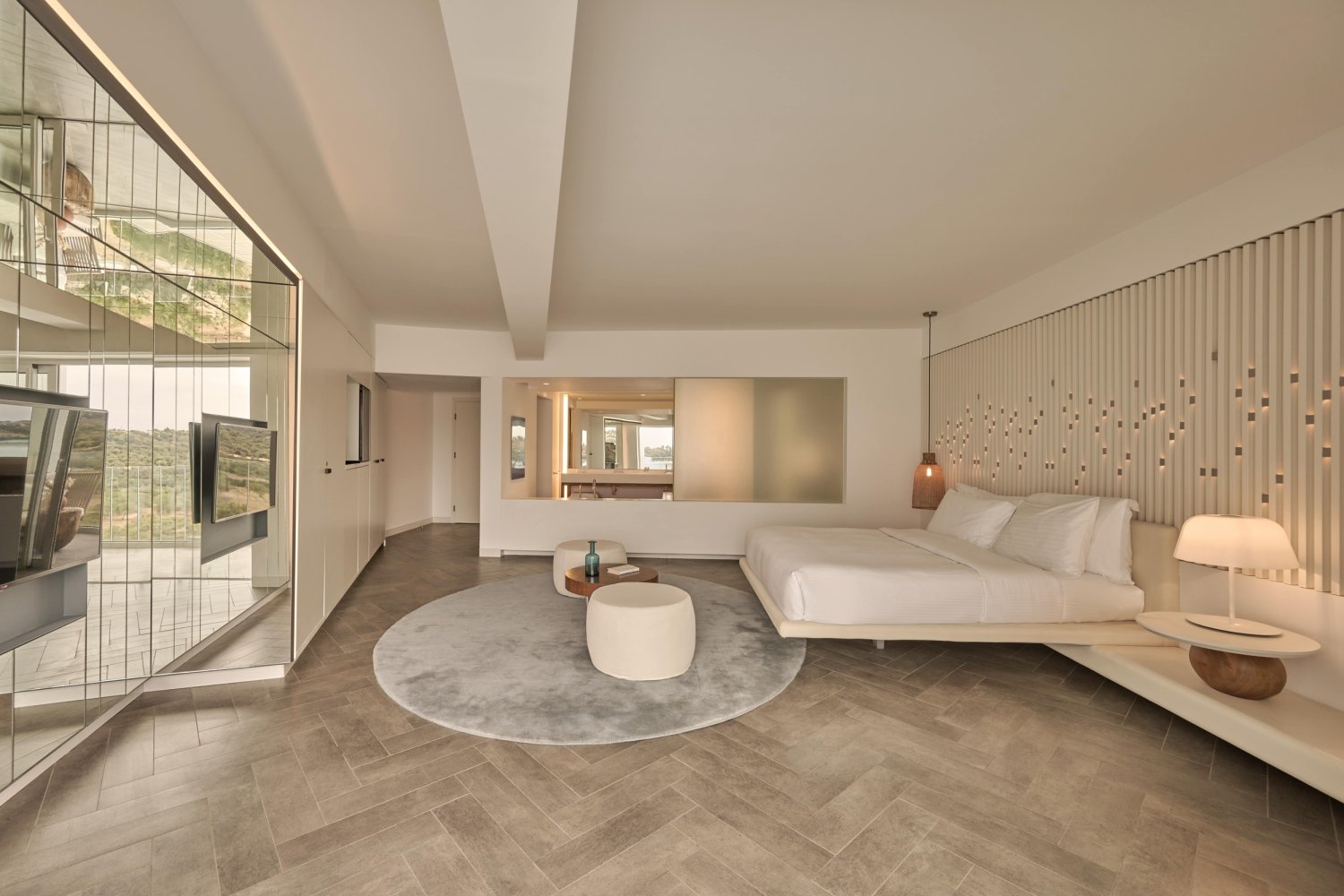 A luxurious modern bedroom featuring a large bed and a sleek television, designed for ultimate relaxation and comfort
