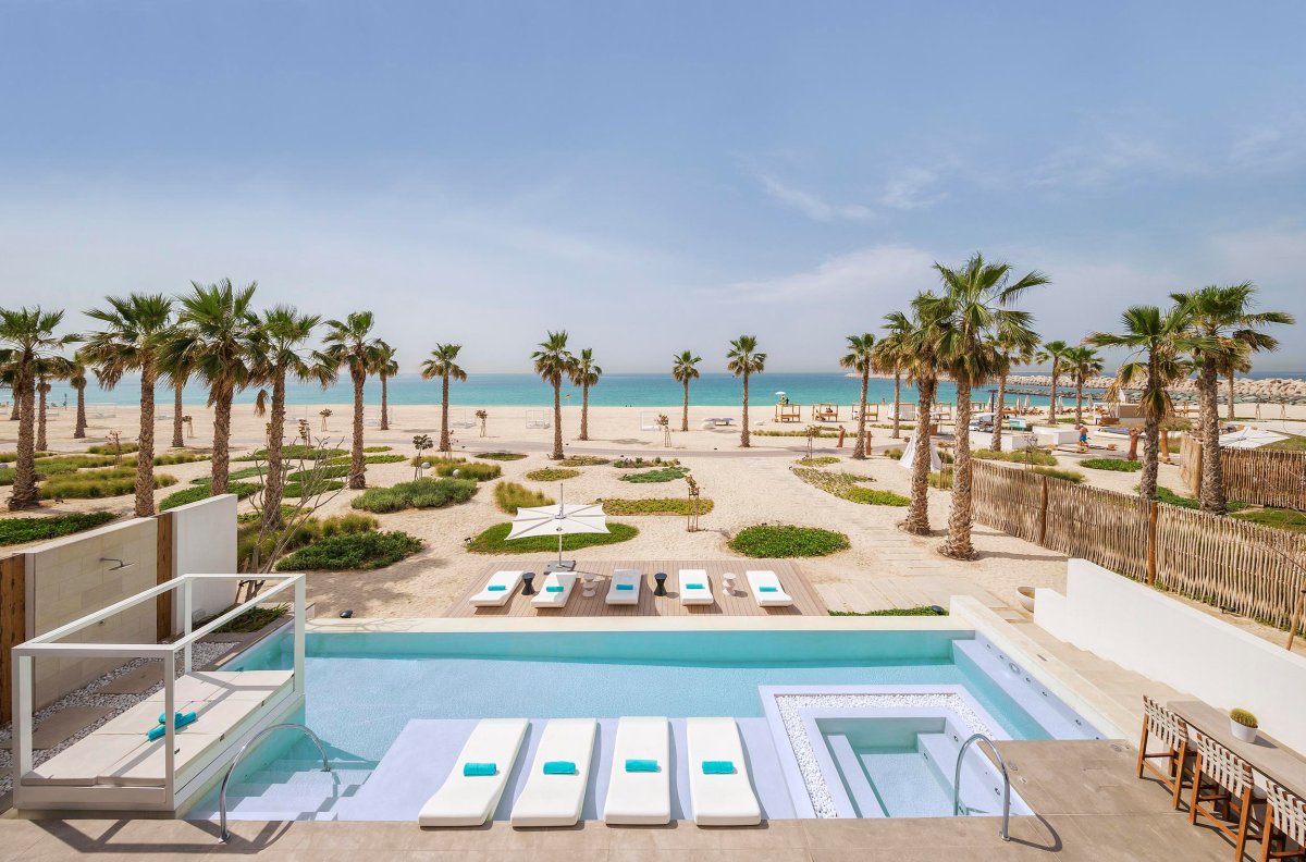 view of the private pool and sun loungers leading straight onto the beach front