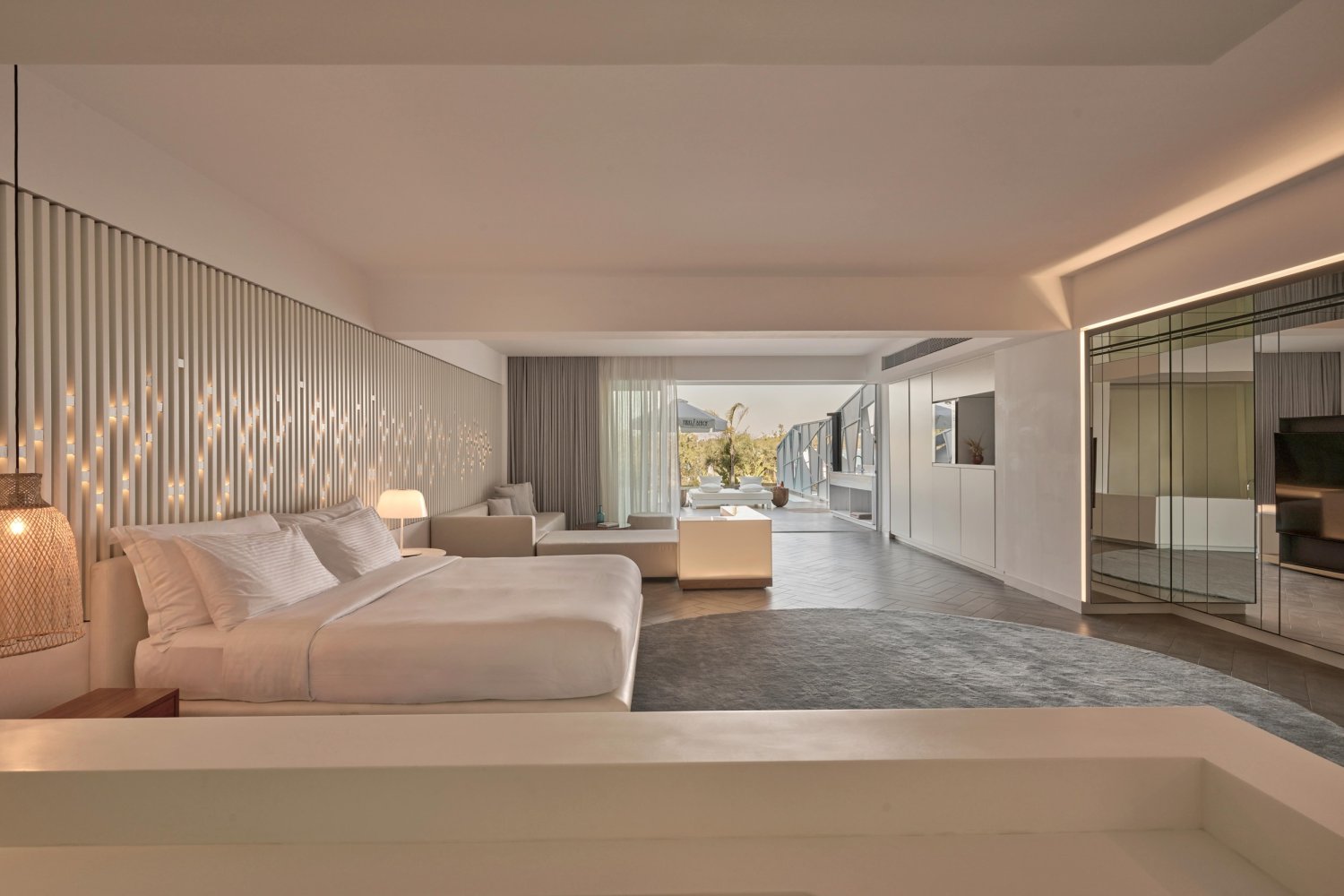 Elegant hotel suite with a plush bed, modern television, and inviting decor, perfect for a luxurious getaway