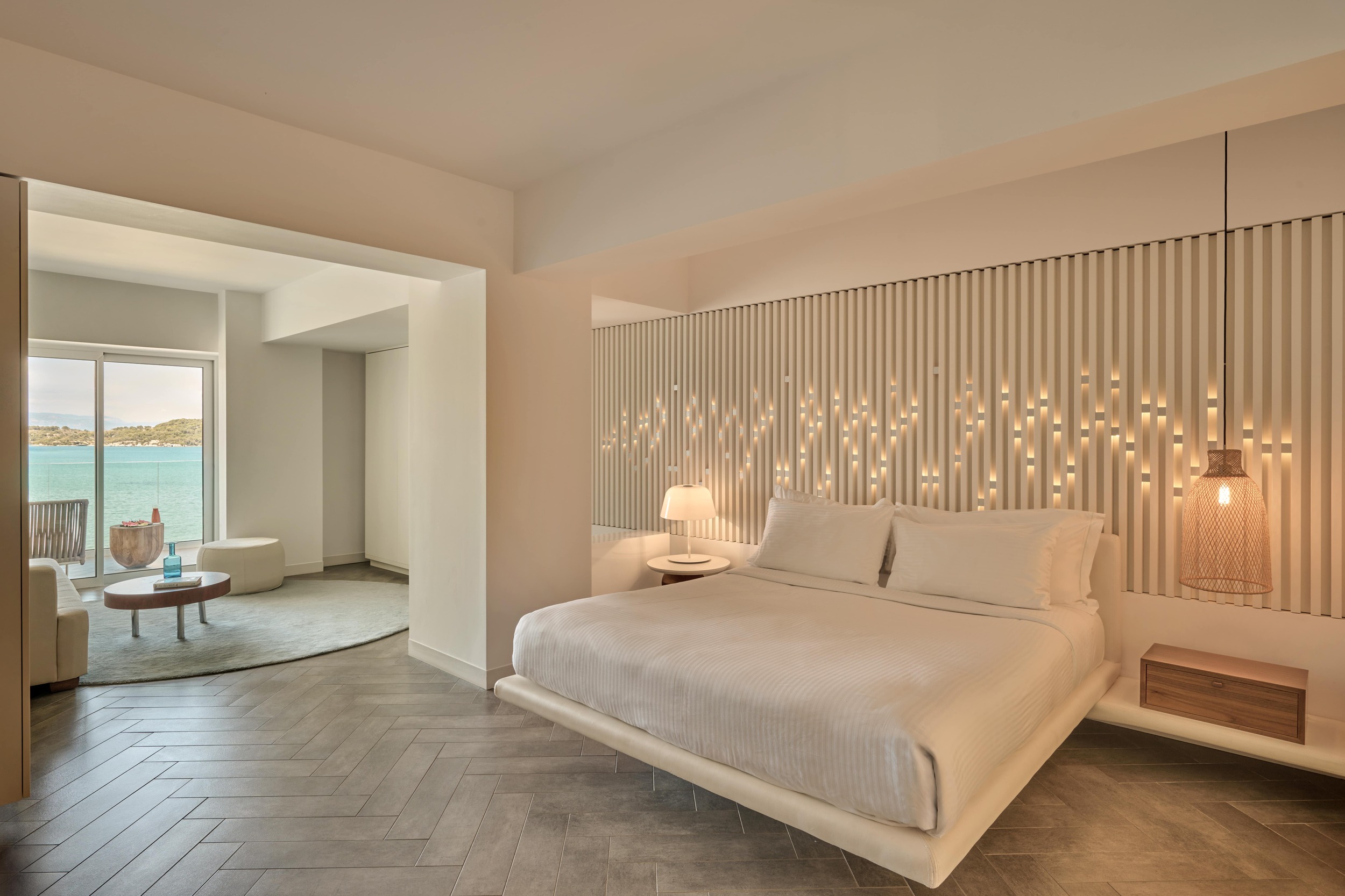 A luxurious bedroom featuring a king bed and a stunning sea view, perfect for relaxation at Nikki Beach Porto Heli