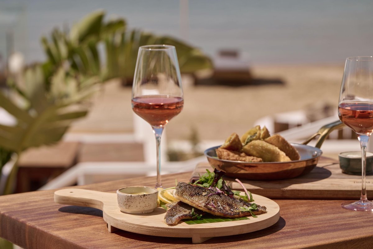 A fish dish paired with a glass of wine