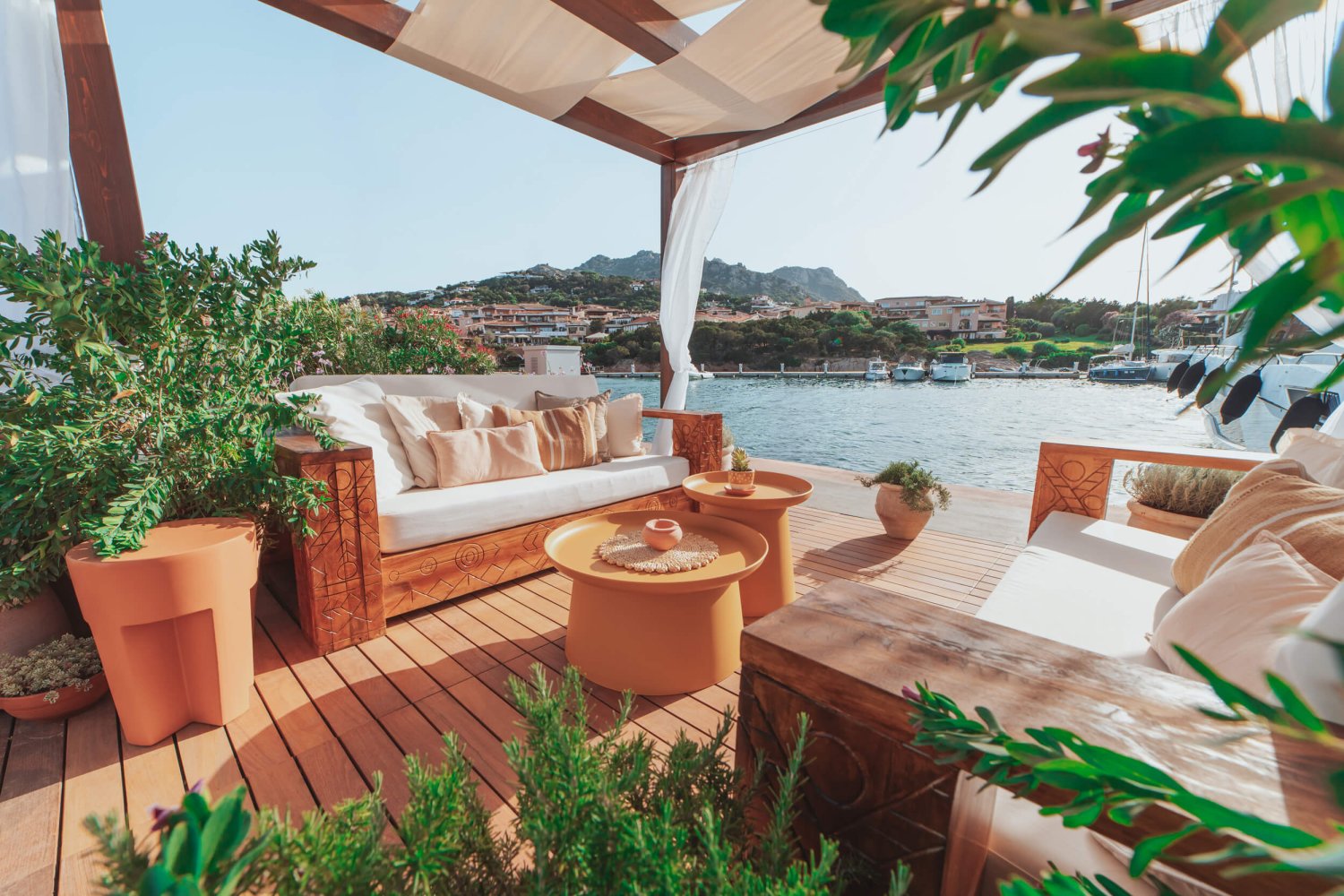 Seating area next to the harbour surrounded by plants