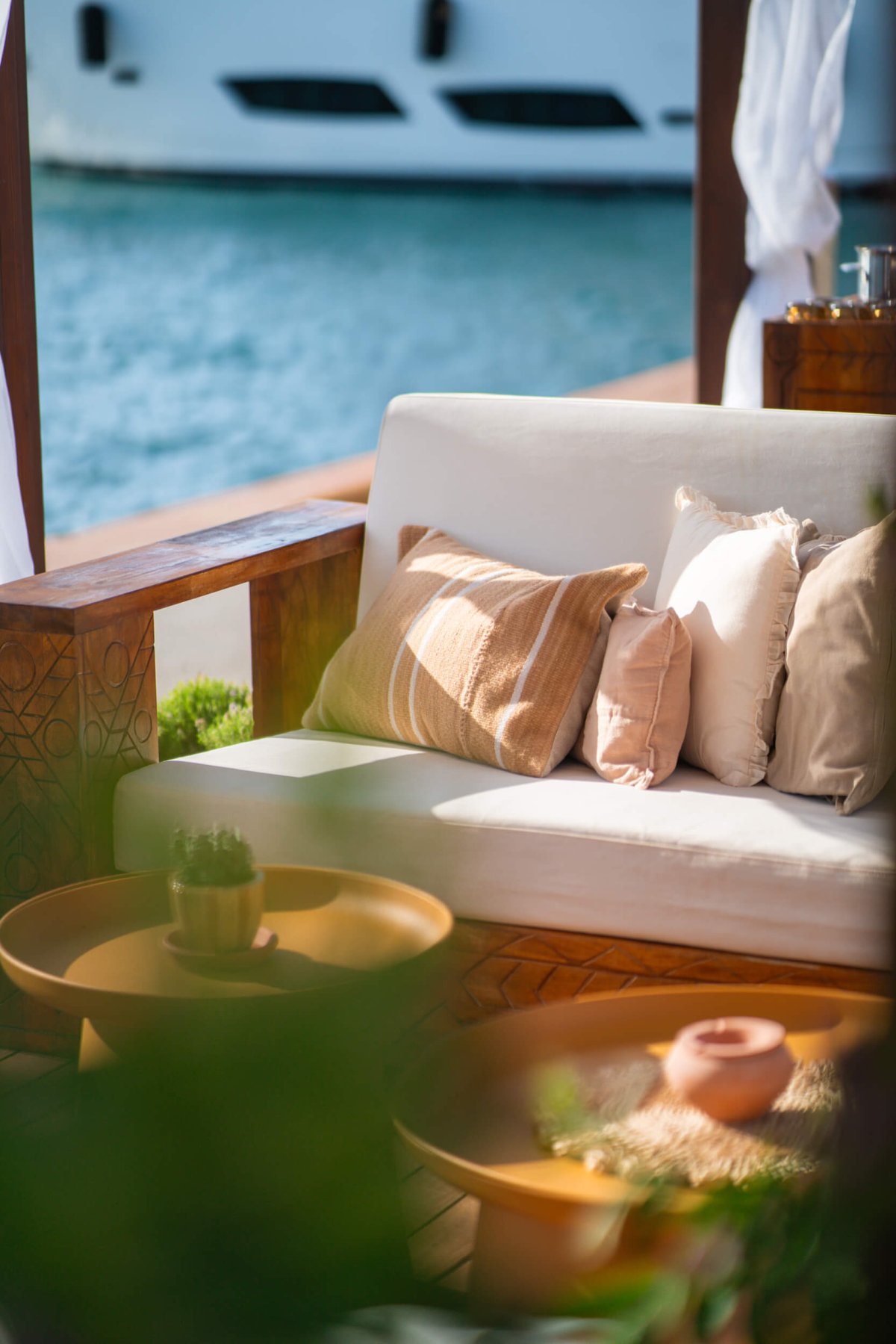 Close up of a cushioned seating area next to the harbour